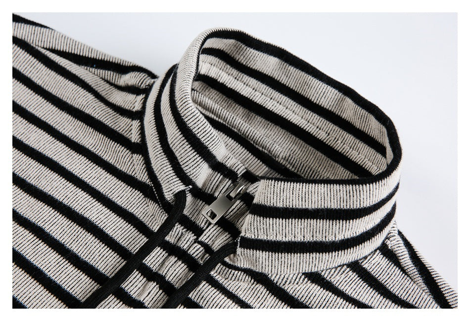 Close-up of a cream and black striped high collar with a short front zipper.