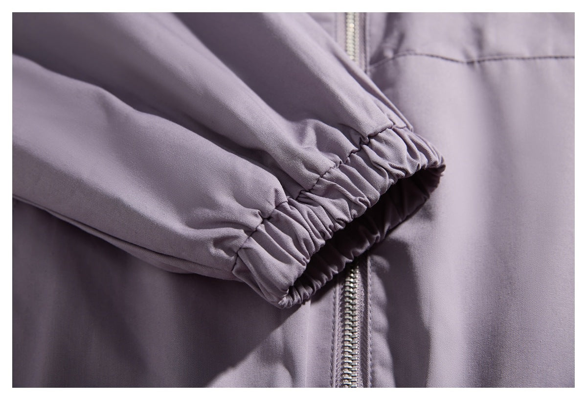 Close-up of a gathered elastic jacket cuff beside the front zipper.