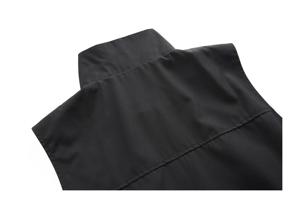 Close-up of the black jacket's raised collar and upper back seam.