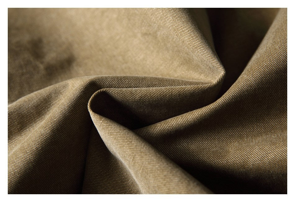 Close-up showing the fine woven texture and soft folds of khaki-brown fabric.