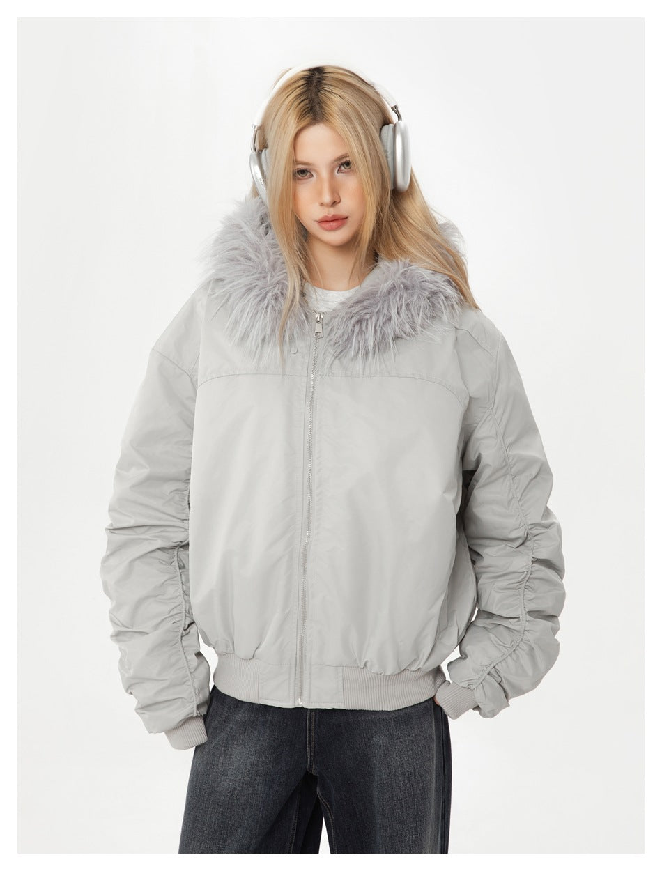 Model wearing a zipped light gray fur-collar jacket with gathered sleeves.