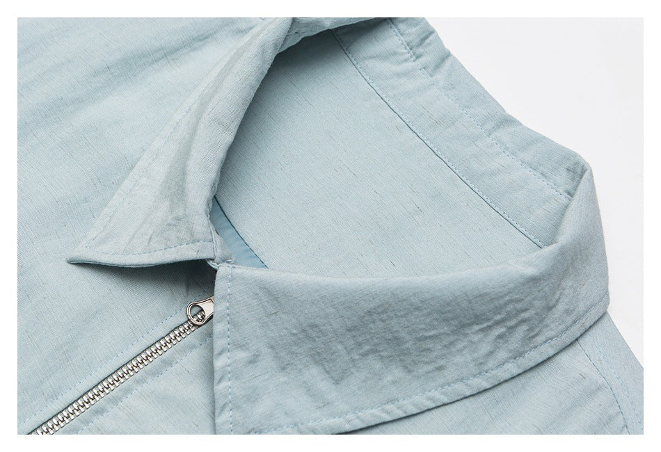 Close-up of the pale blue jacket's wide collar, inner facing and silver front zipper.
