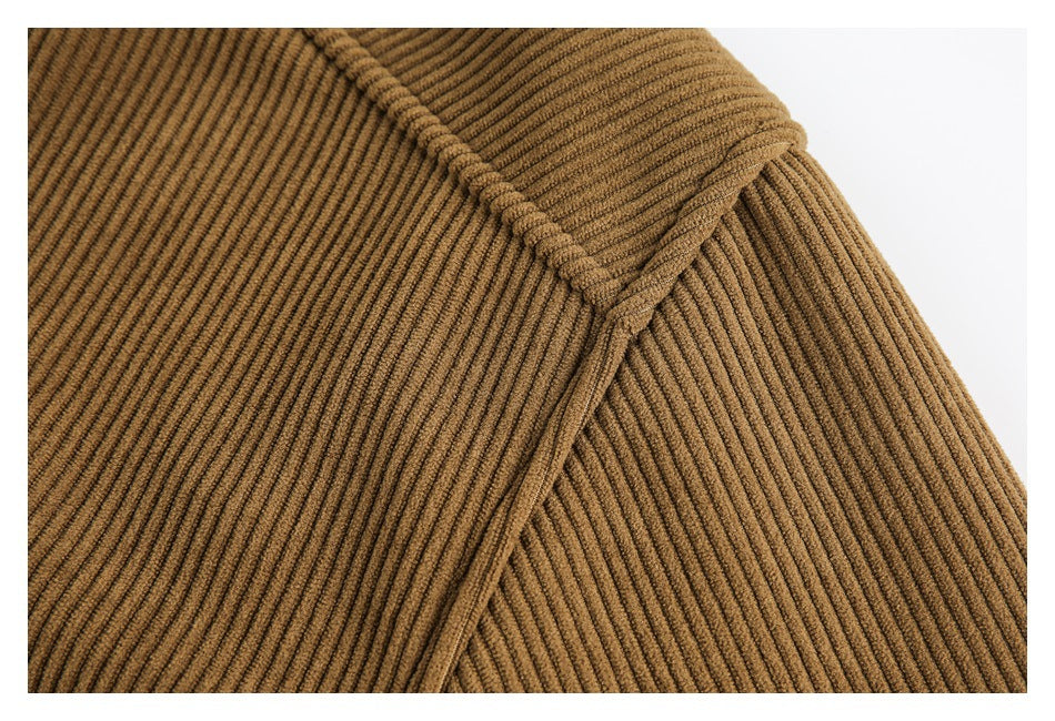 Close-up of the camel-brown ribbed jacket's shoulder seam and sleeve construction.
