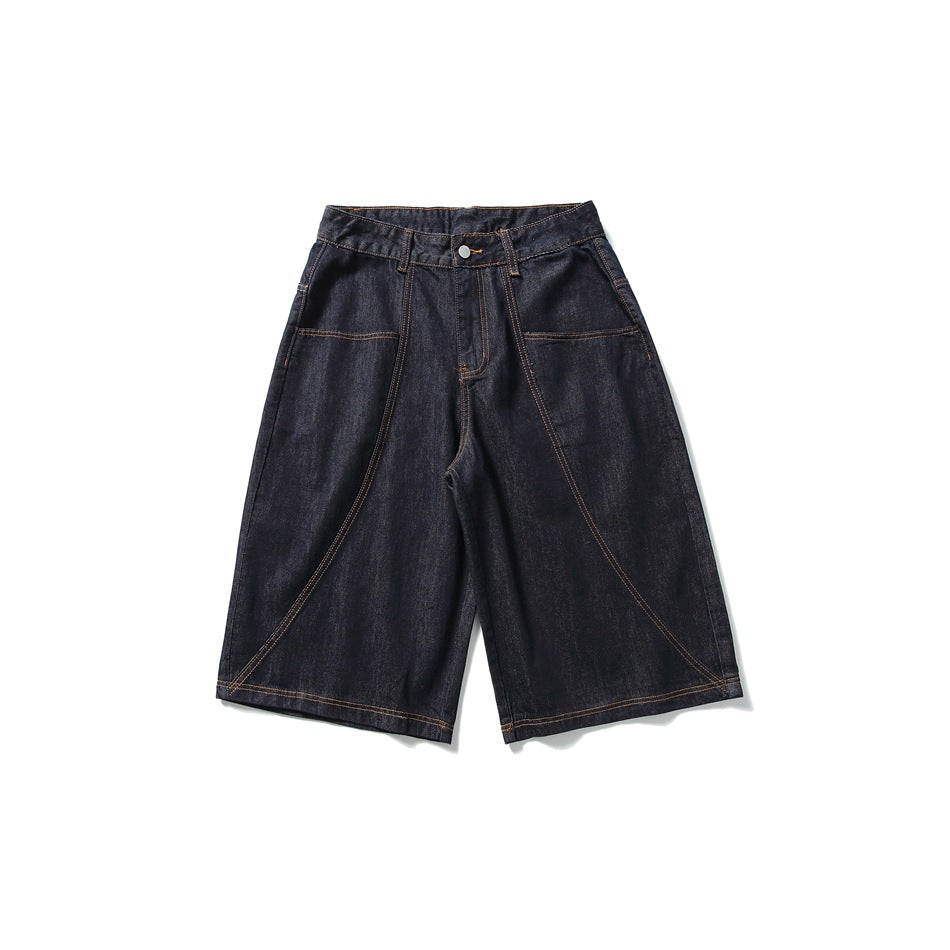 Dark indigo denim knee-length shorts, flat front view with curved seams, front pockets and orange topstitching