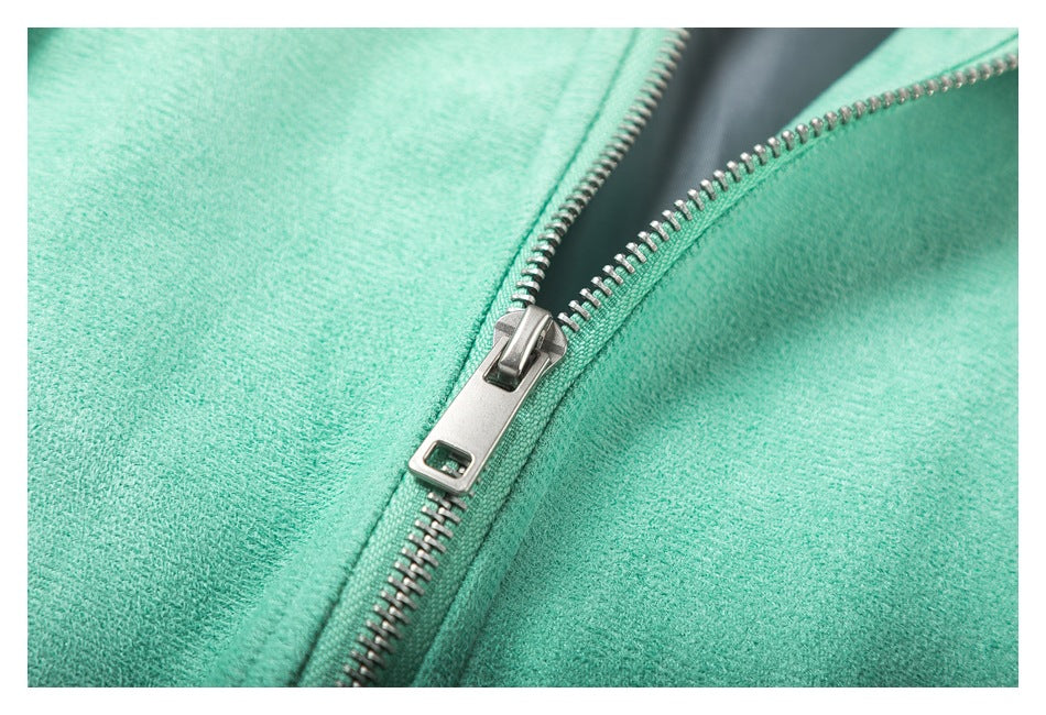 Close-up of the jacket's silver zipper and mint-colored fabric.