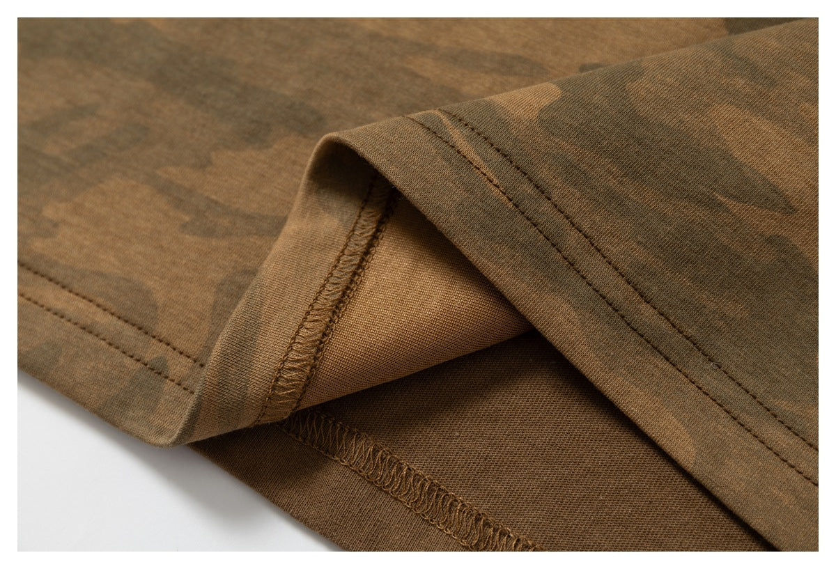 Close-up of a turned garment hem showing brown overlock stitching and the inside seam.