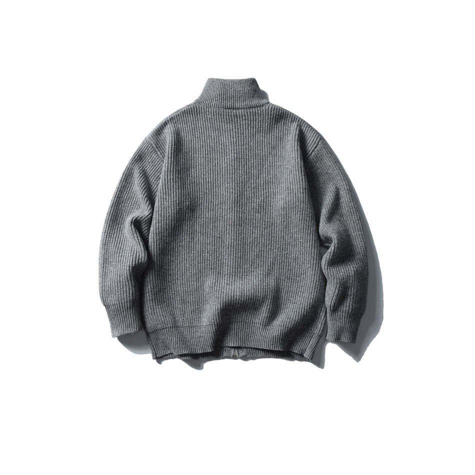Back view of a medium-gray rib-knit sweater laid flat, showing its high collar and long sleeves.