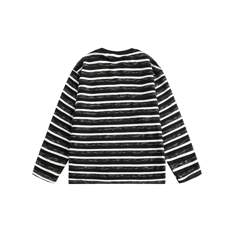 Back view of a black-and-cream horizontally striped long-sleeve shirt with a black ribbed crew neck.