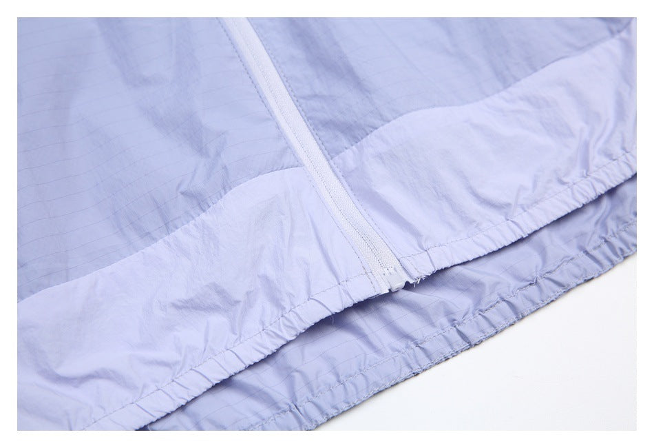 Close-up of the lavender garment's white zipper and gathered hem.
