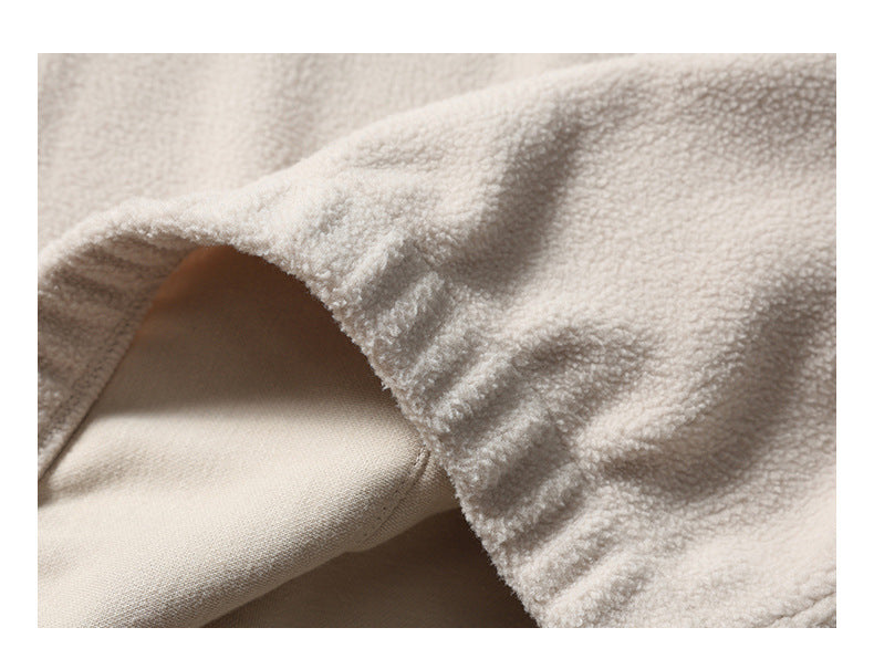 Close-up showing the ivory plush fabric folded back to reveal its smooth inner side.