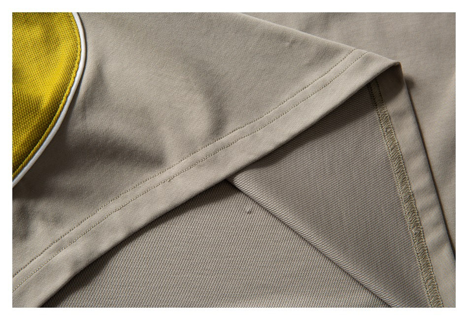 Close-up of the shirt hem and underside, showing fabric texture and overlocked seam stitching.