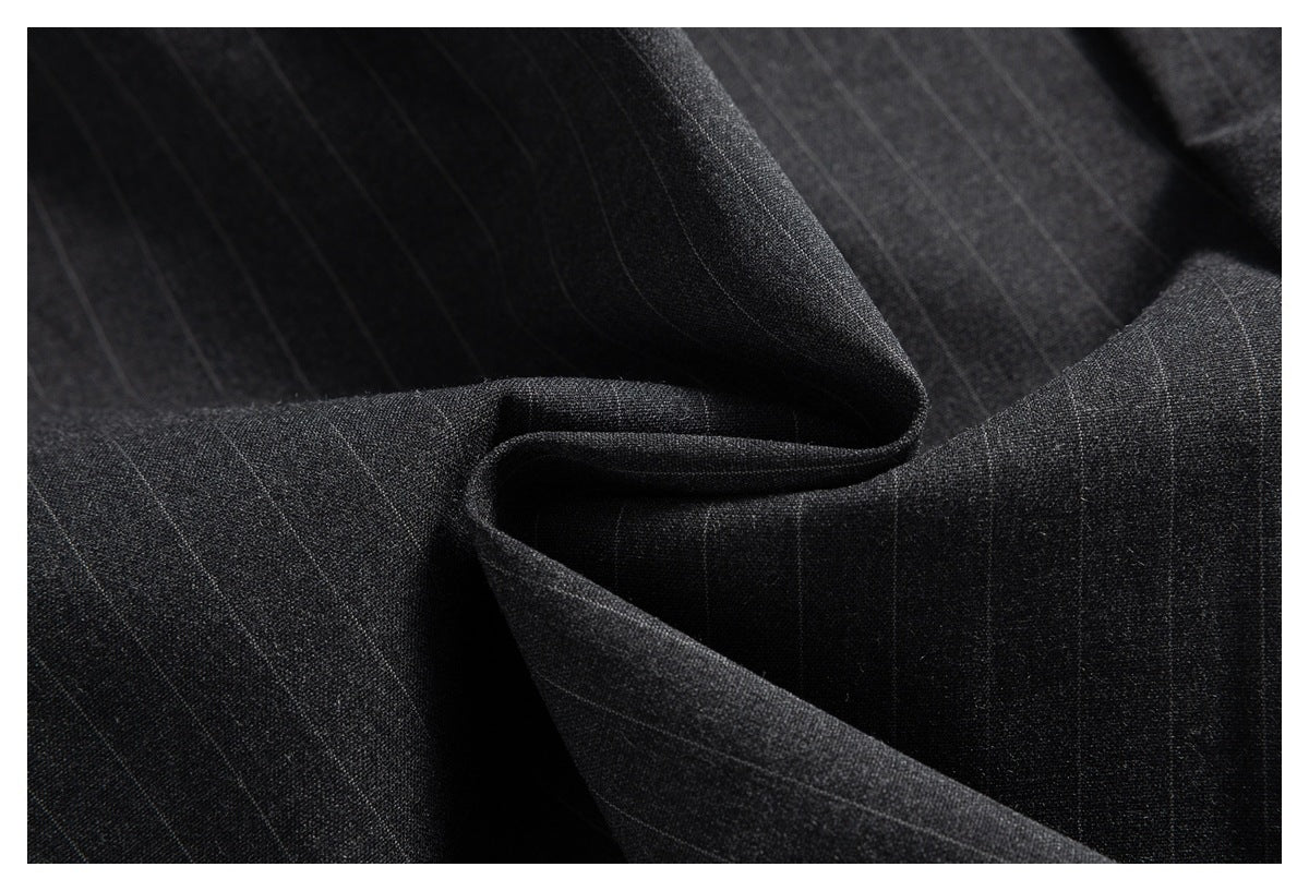 Close-up of dark charcoal fabric with a subtle, thin windowpane pattern and soft folds.