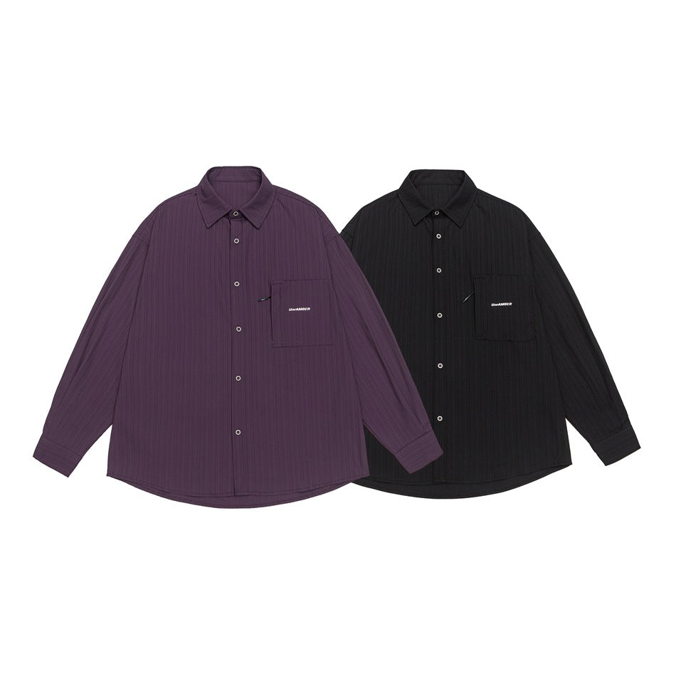 Two button-up shirts displayed together: one plum and one black, each with a chest pocket.