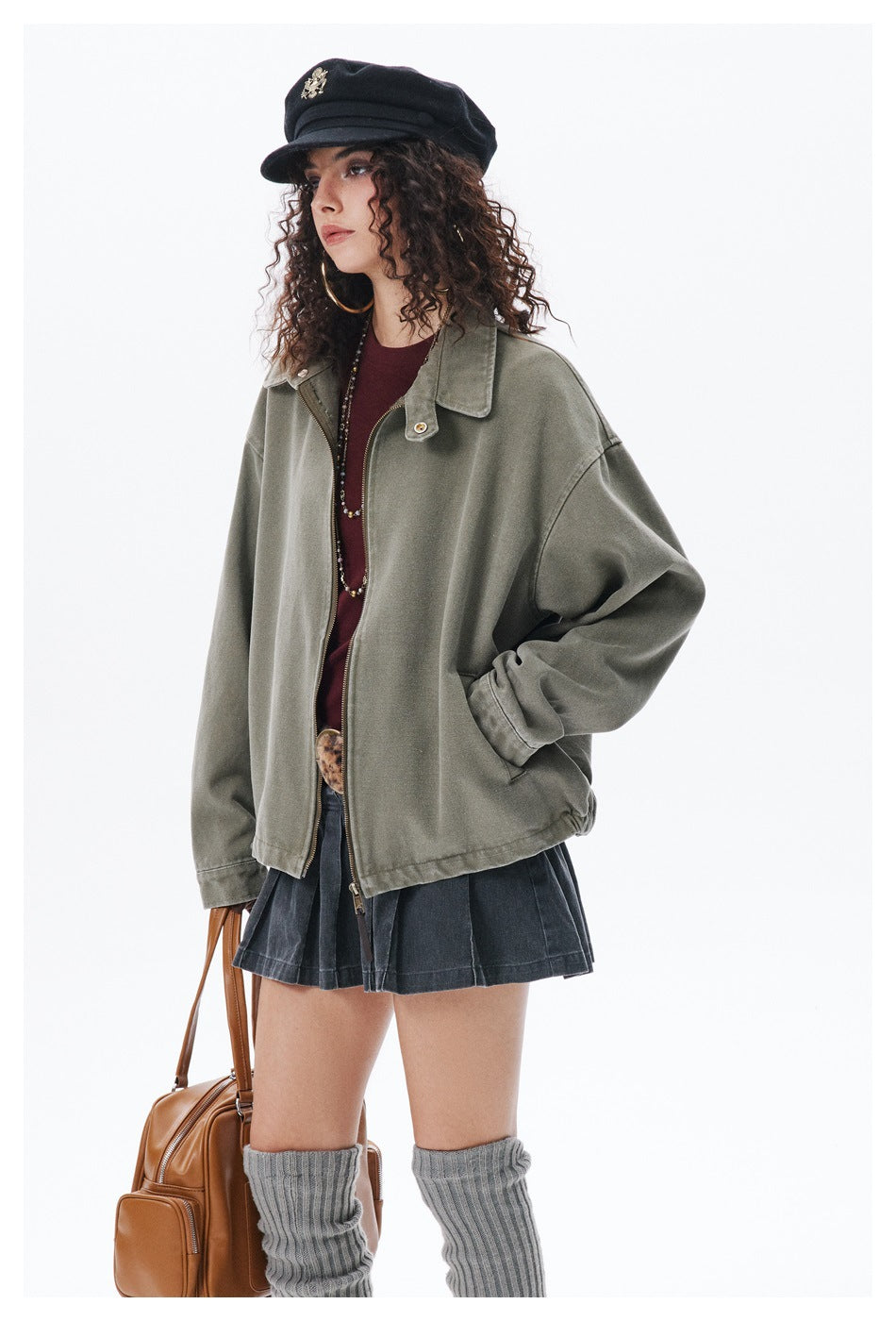 Model wearing an oversized olive-gray collared jacket with a front zipper and roomy sleeves.