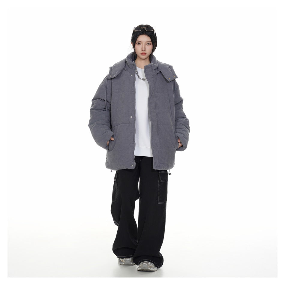 Model wearing an open gray hooded jacket with snap details over a white top, showing its front and pockets.