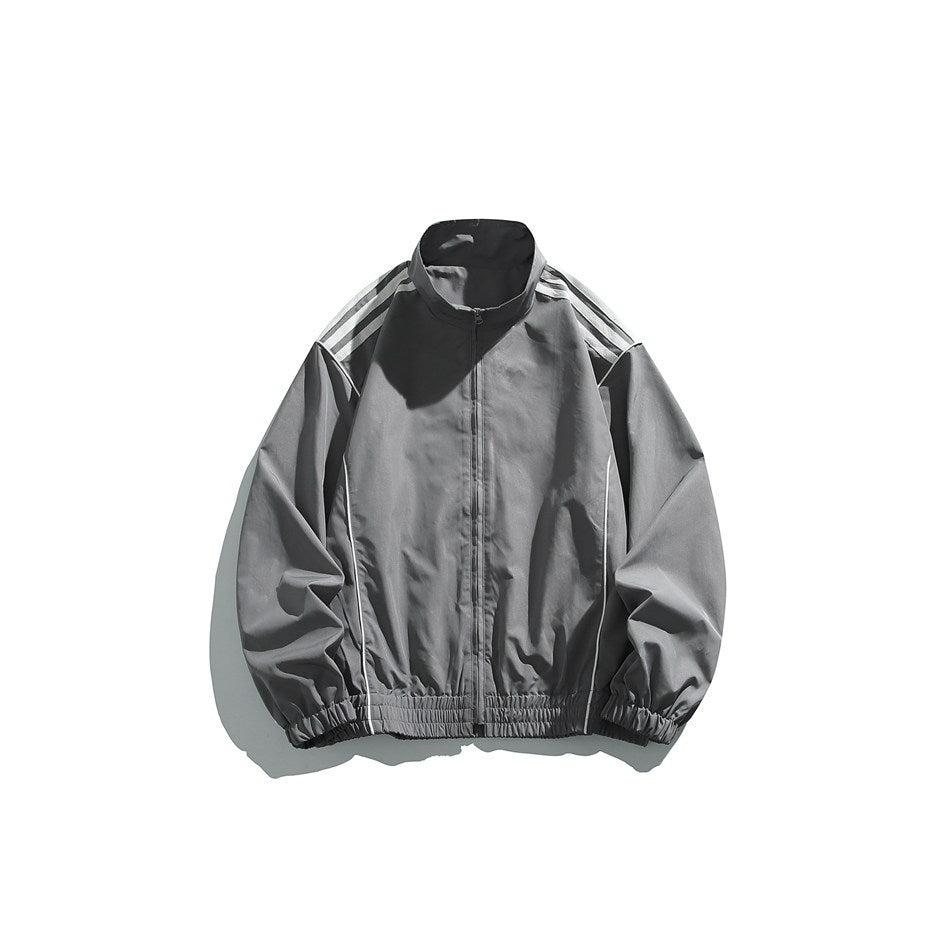 Gray stand-collar zip track jacket with white shoulder stripes, white piping and elastic cuffs and hem, flat lay front view