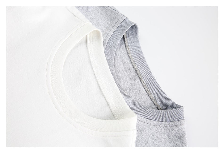 Close-up of the crew necklines of white and light gray T-shirts.
