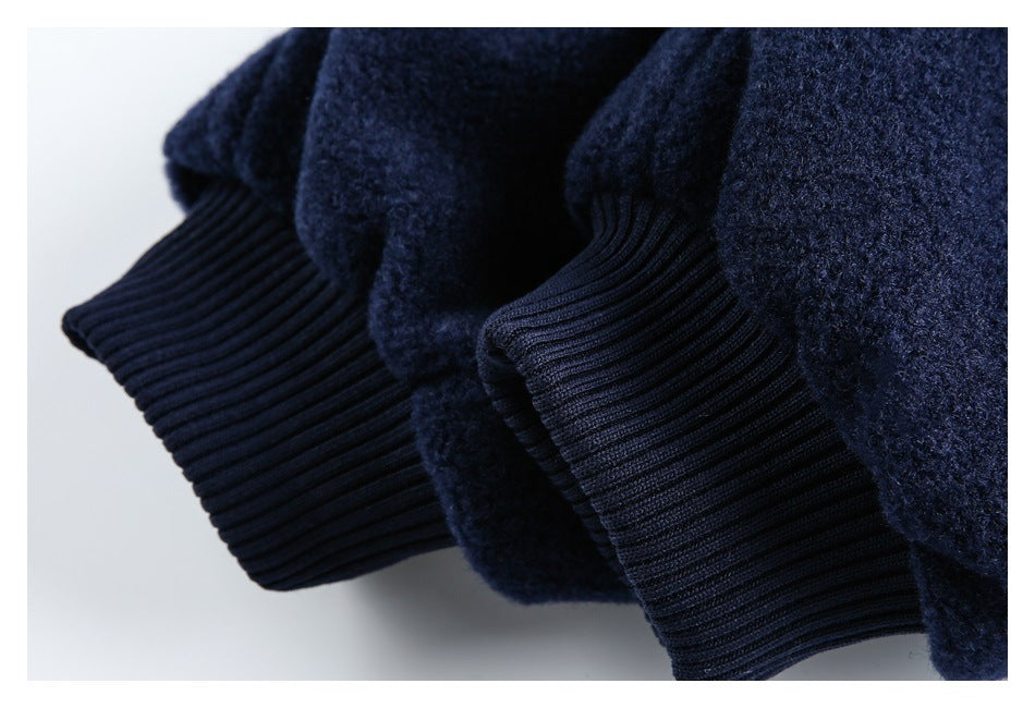 Close-up of dark navy ribbed cuffs against the garment's textured fabric.