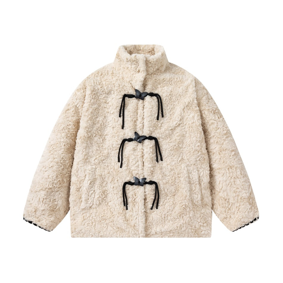 Cream fleece-textured jacket with stand collar and three black butterfly toggle closures, flat front view