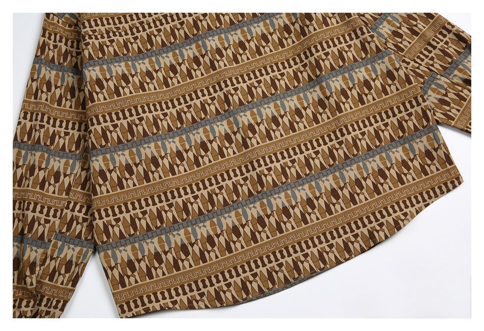 Close view of the lower back of a flat-laid shirt, showing its geometric banded print and hem.
