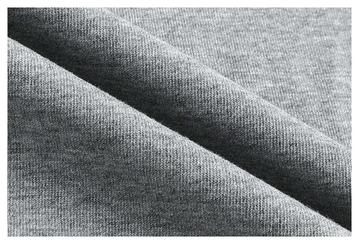 Extreme close-up of gray knit fabric folded to show its fine texture.