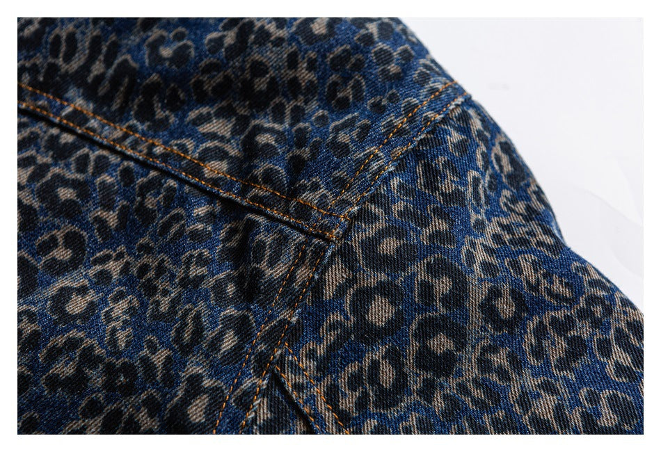 Close-up of leopard-print denim at a shoulder seam with orange topstitching.