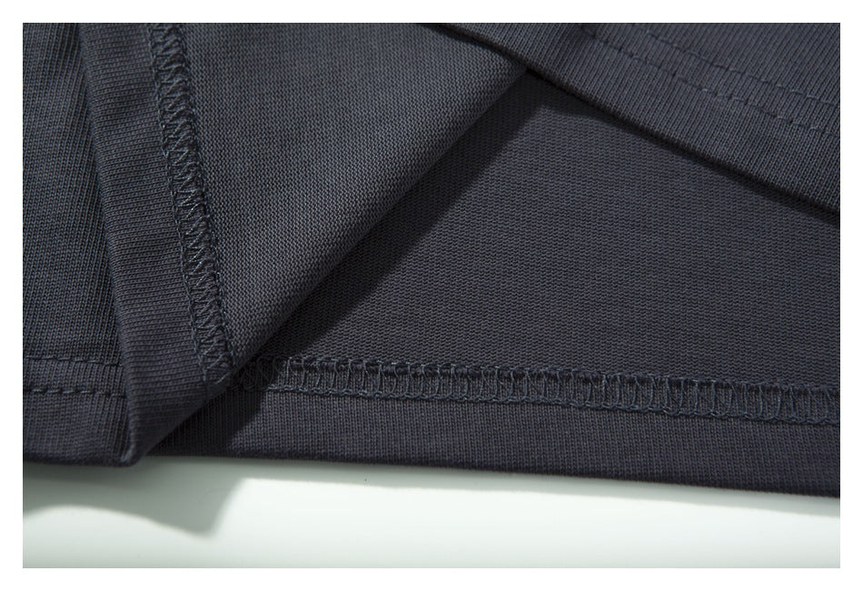 Close-up of dark garment fabric showing an inside seam and stitched hem.