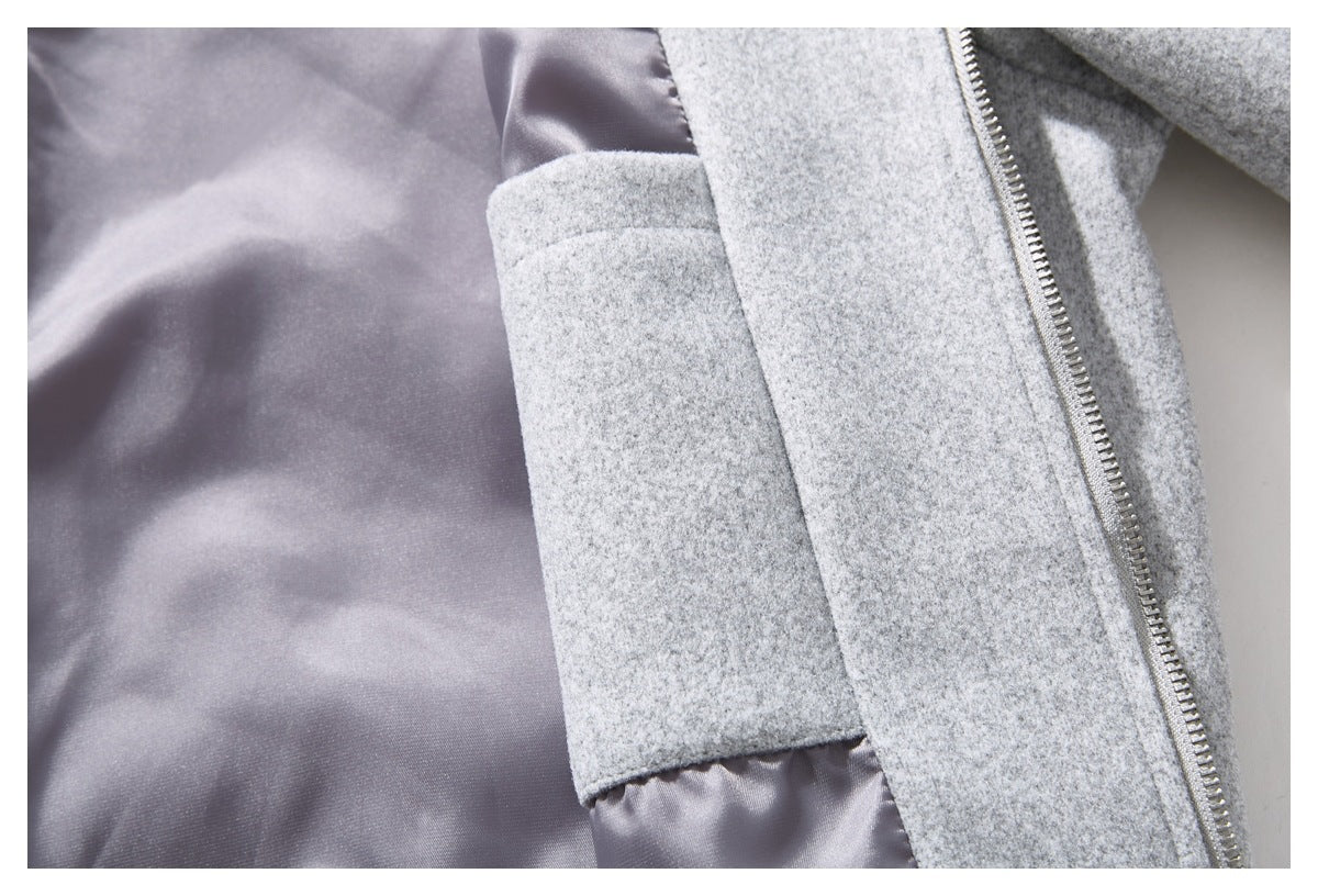 Open light gray coat showing smooth gray lining and an interior pocket beside the zipper.