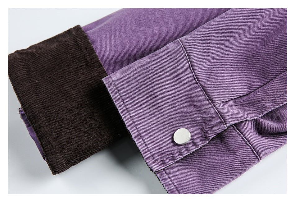 Close-up of a purple cuff with a silver snap and dark ribbed inner cuff.