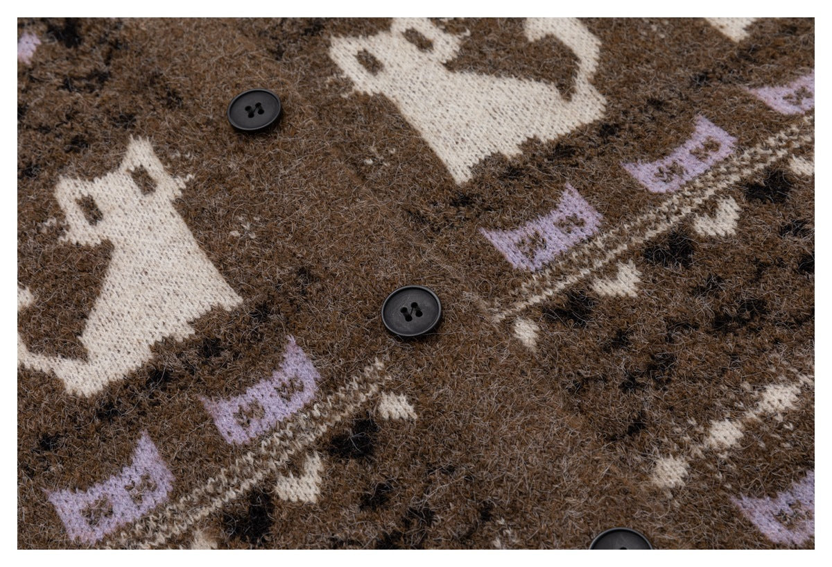Close-up of the brown cardigan's patterned knit, showing black buttons and cream and lavender motifs.