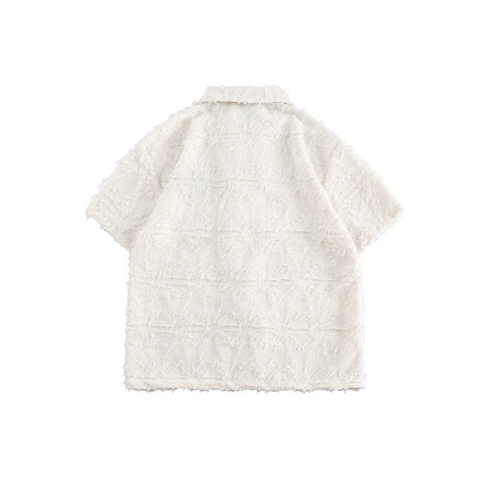 Flat-lay back view of an ivory short-sleeve collared shirt with a raised geometric pattern and fringed edges.