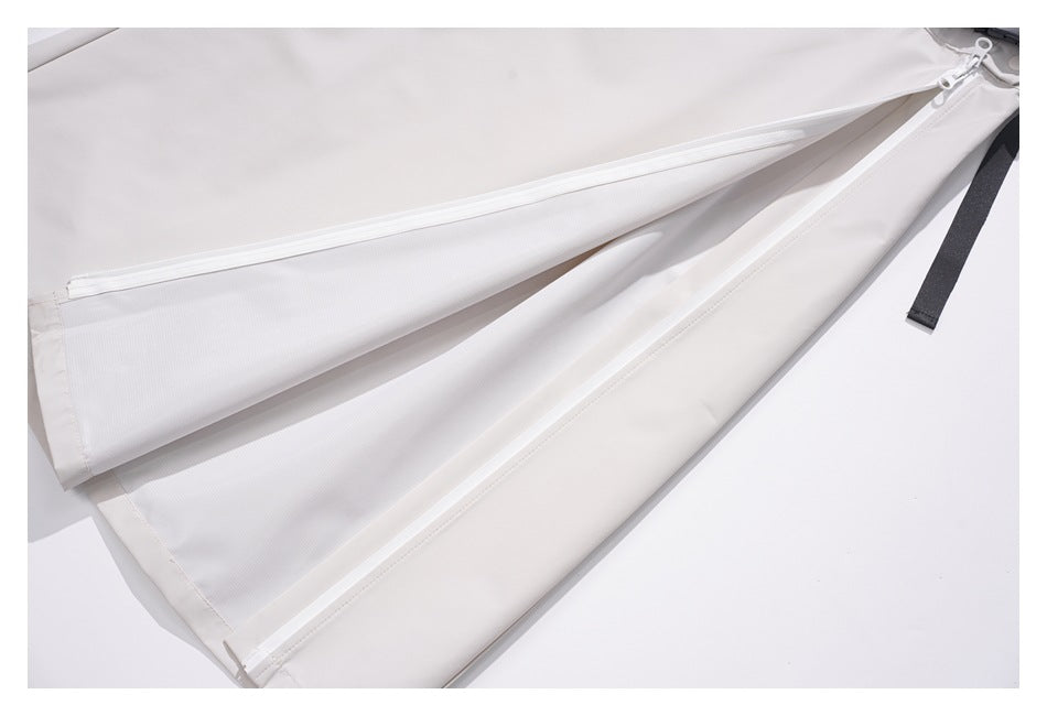 Off-white garment panel opened to show long white zippers and a black fabric tab.