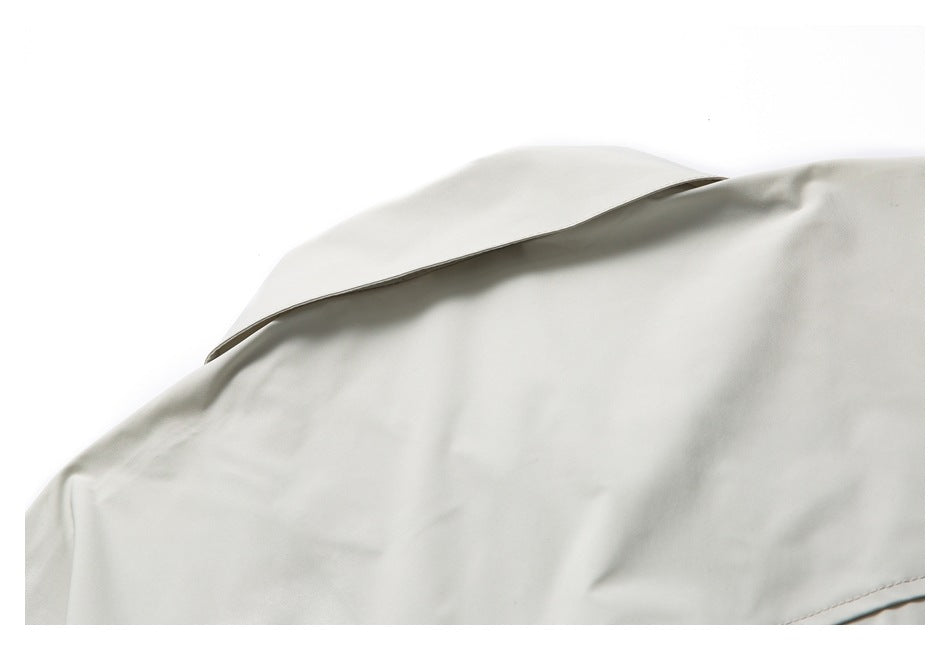 Close-up of the pale gray shirt collar and upper fabric against a white background.