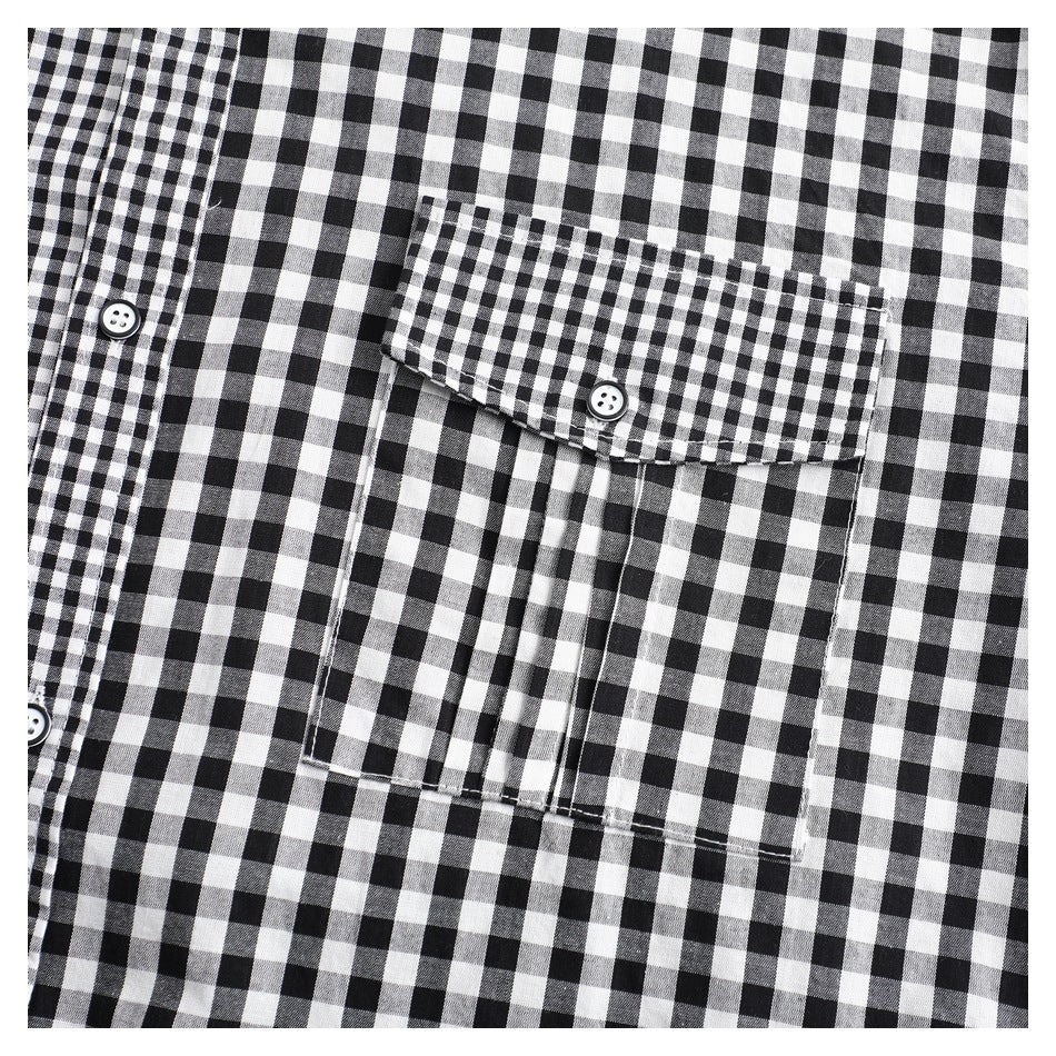 Close-up of a black-and-white gingham shirt pocket with button flap and front placket.