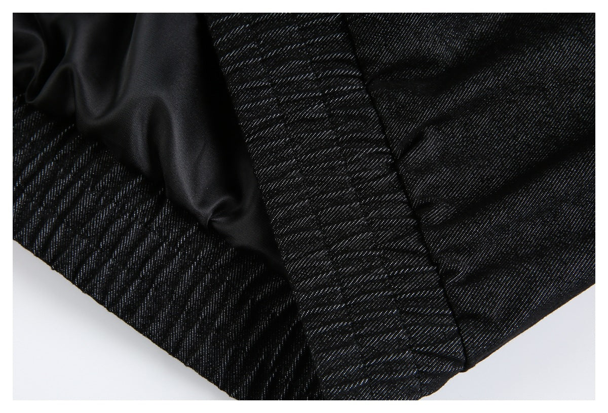 Close-up of black garment construction showing a smooth lining and stitched panels.