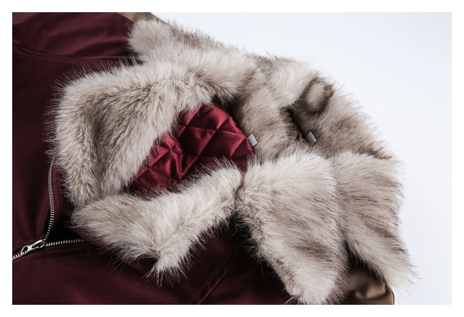 Close-up of the jacket's pale gray fur collar, burgundy quilted lining, and zipper.