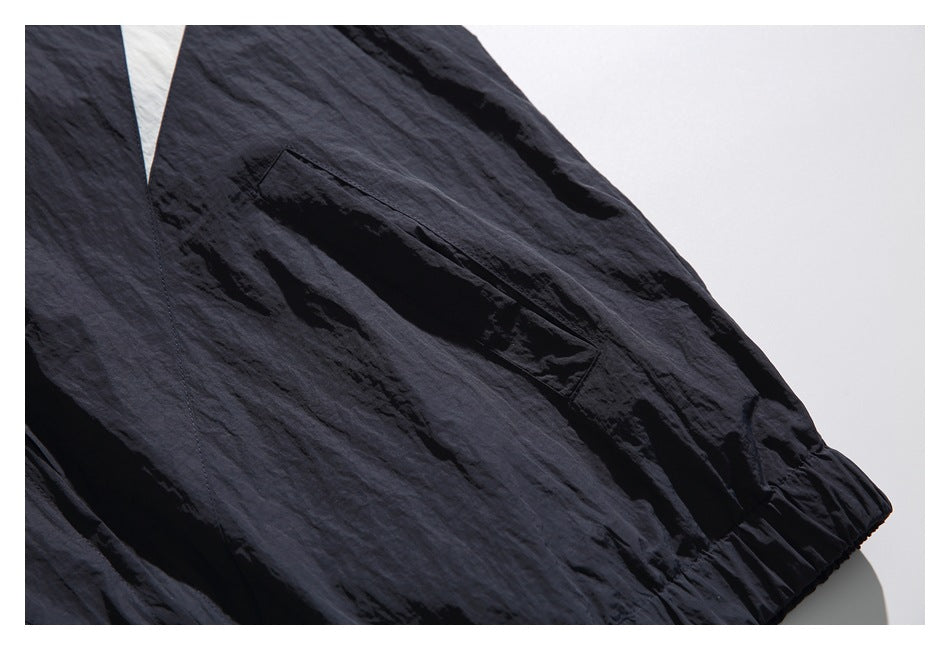 Close-up of a slanted pocket on a dark navy garment.