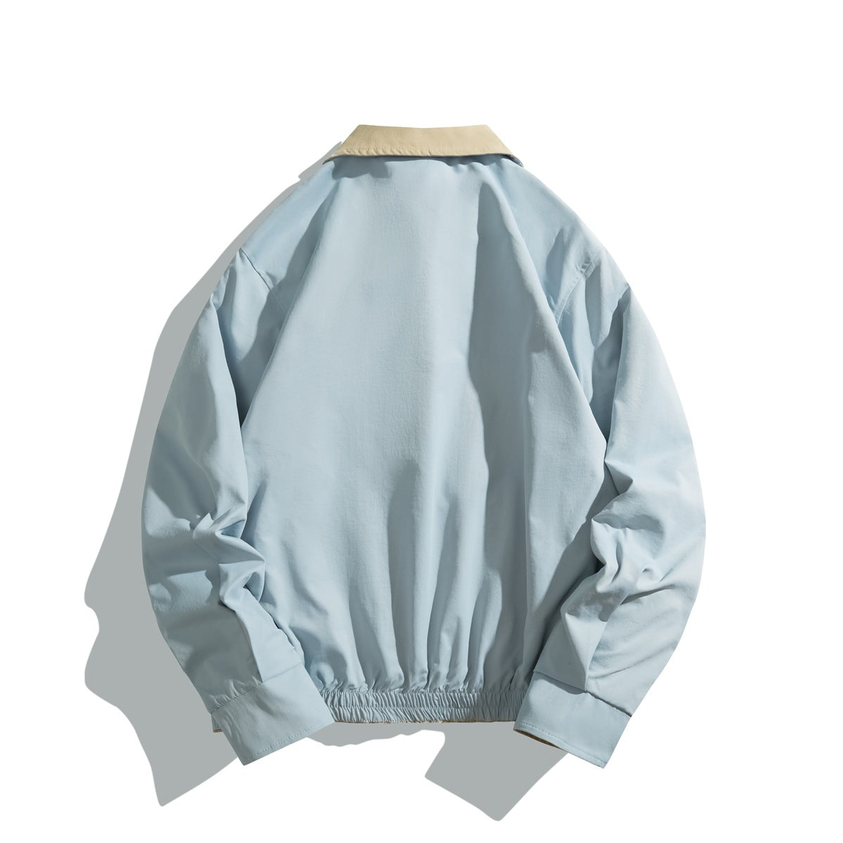 Back view of a pale blue jacket with a beige collar and gathered hem.
