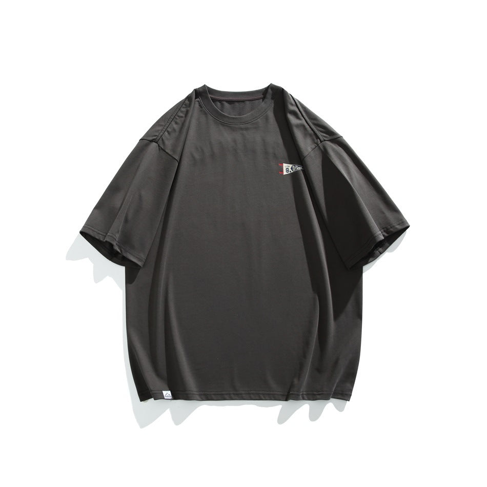 Front view of a charcoal oversized short-sleeve T-shirt with a small pennant graphic on the chest.