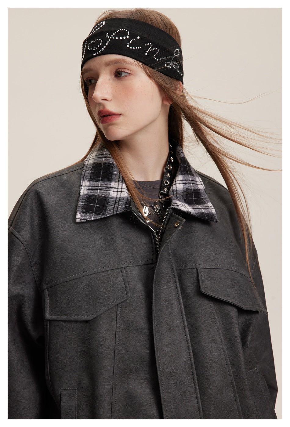Model wearing a charcoal jacket with a contrasting plaid collar and two flap chest pockets.