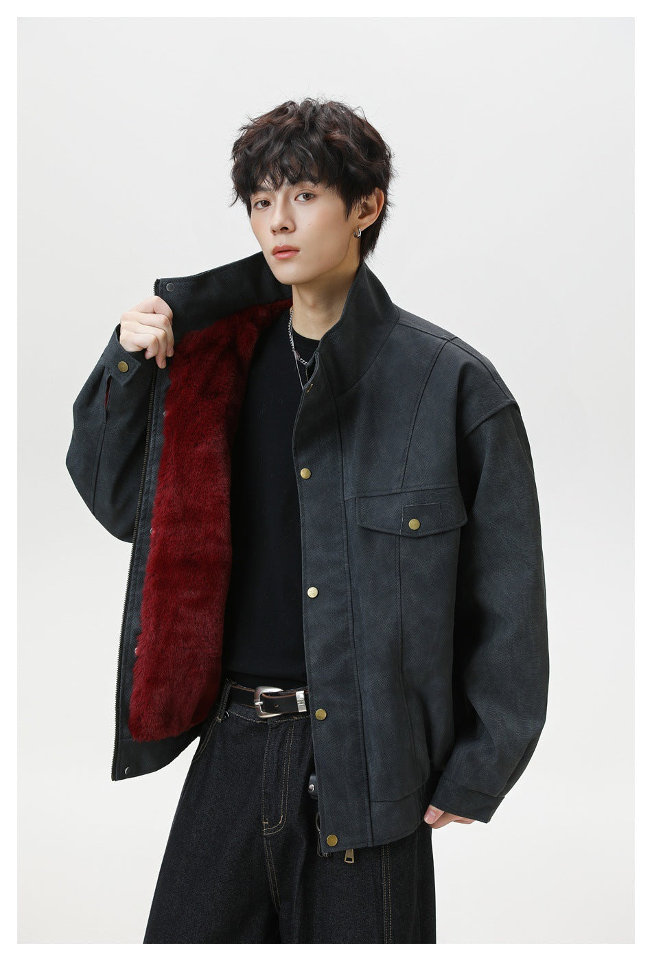 Close view of a model opening the dark jacket to show its deep burgundy lining.
