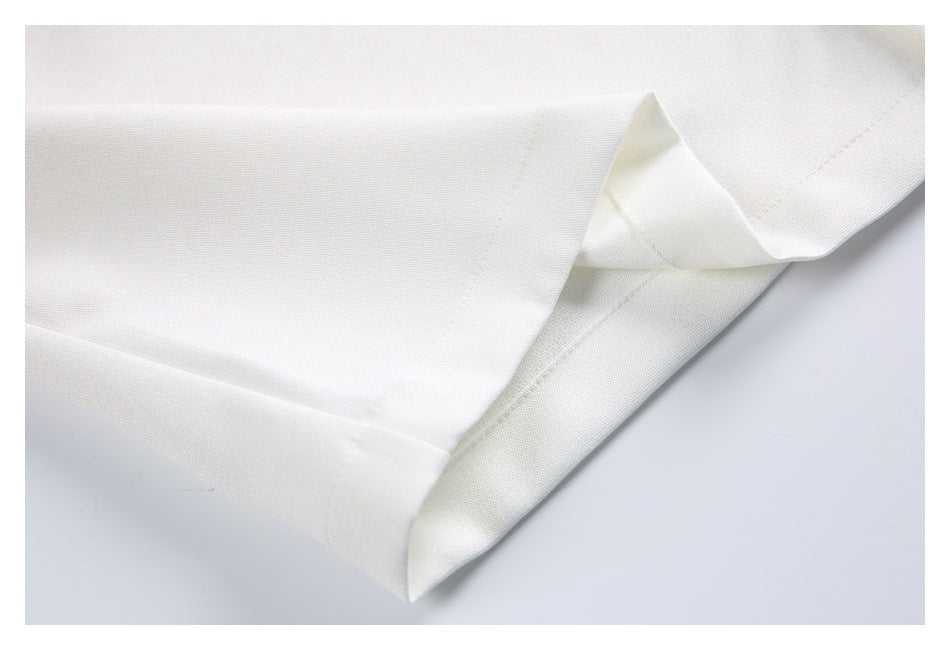Close-up of a white garment edge folded to show its seam and hem.