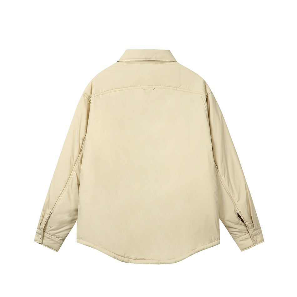 Back view of light yellow quilted shirt-style jacket with back yoke seam and snap cuffs, flat lay