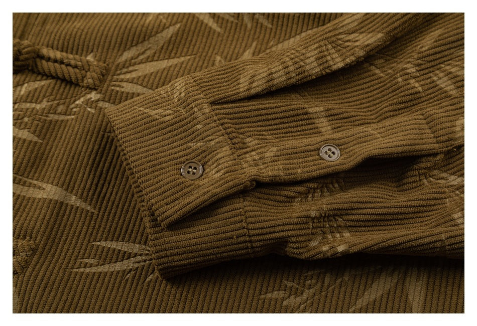 Close-up of two buttons on a brown corduroy shirt cuff, with a subtle geometric pattern across the fabric.