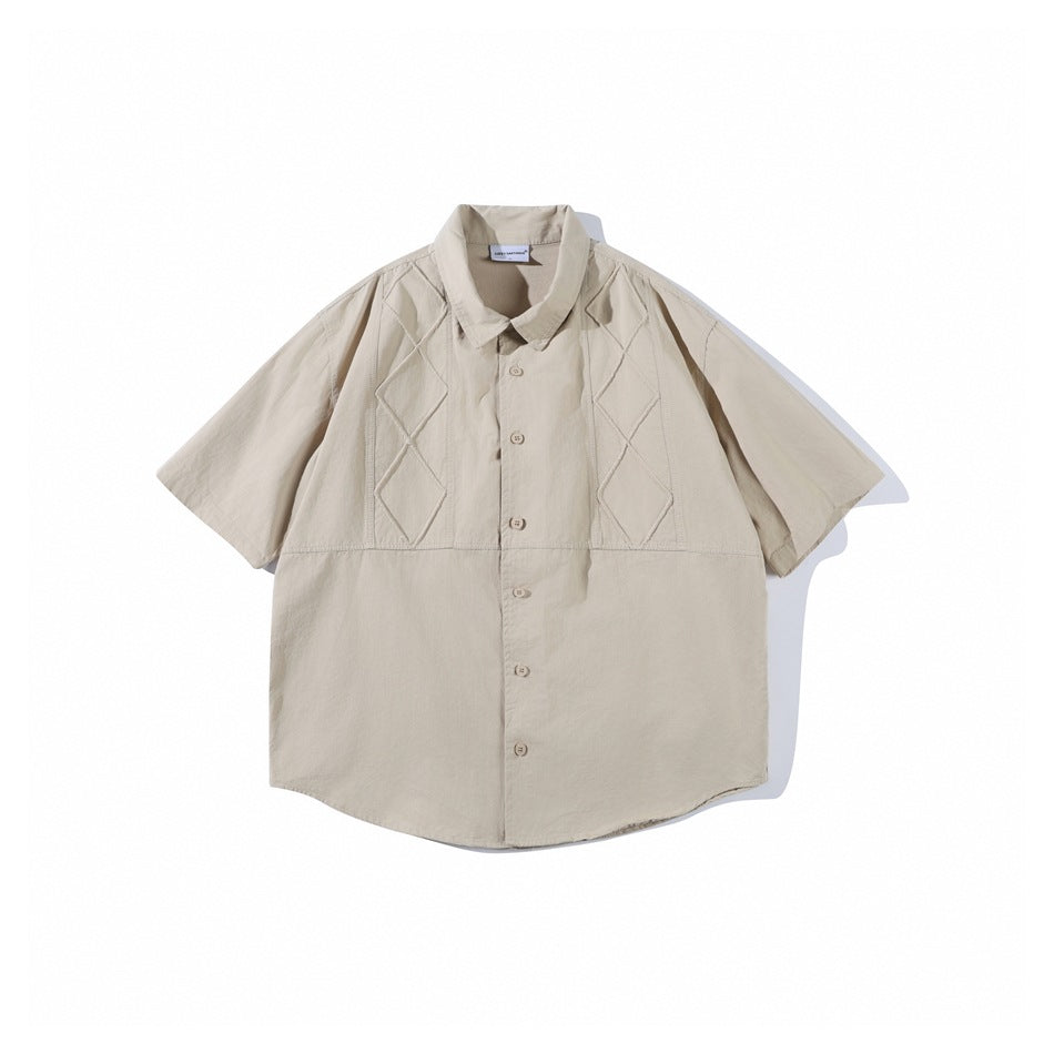 Khaki short-sleeve button-up shirt flat lay with diamond-stitched chest panels and a pointed collar