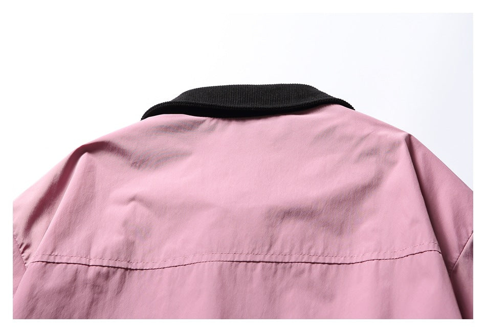 Cropped rear view of a pink jacket showing its black ribbed collar and horizontal back seam.