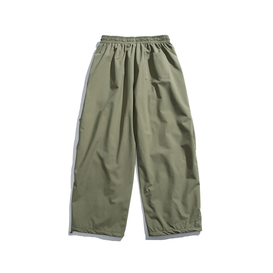 Olive-gray wide-leg pants shown from the back, with an elastic waistband and a single patch pocket.