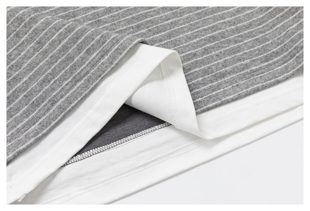 Folded hem showing the gray-and-white striped shirt's white inner facing and stitching.