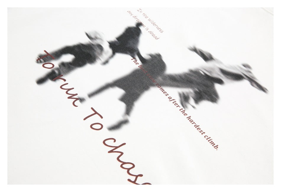 Close-up of a dark blurred-figure graphic and reddish English lettering printed on off-white fabric.