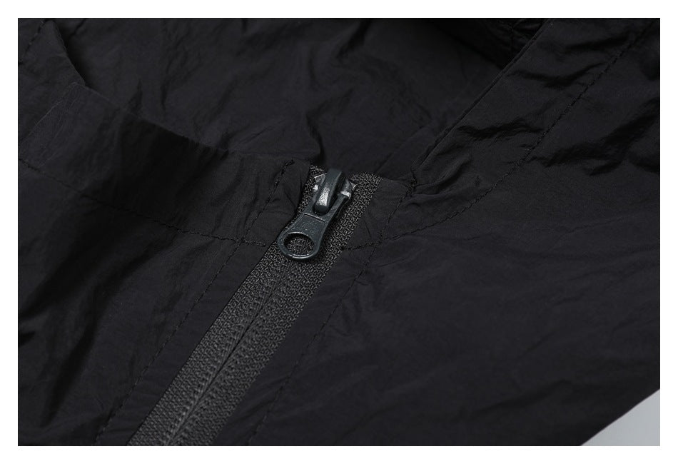 Close-up of a black jacket's zipper and stitching.